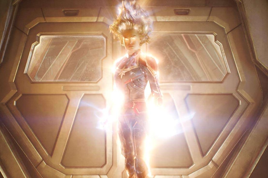 Captain Marvel flying and glowing with power.