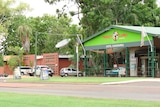 A Thirsty Camel bottle shop in Kununurra with cars parked outside.