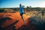 Mina Guli running across the Simpson Desert