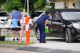 Health staff work at a drive-through coronavirus testing clinic in Townsville.