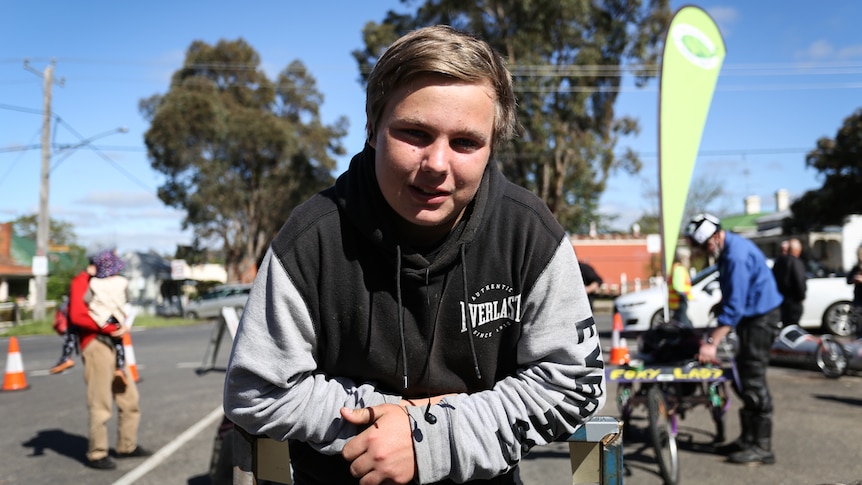 Charlie, 16, leaning on the billy cart.