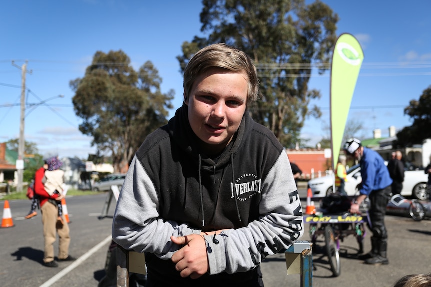 Charley, 16, leaning on the billy cart.