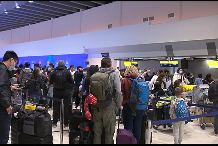 Un terminal de départ d'aéroport plein de monde.