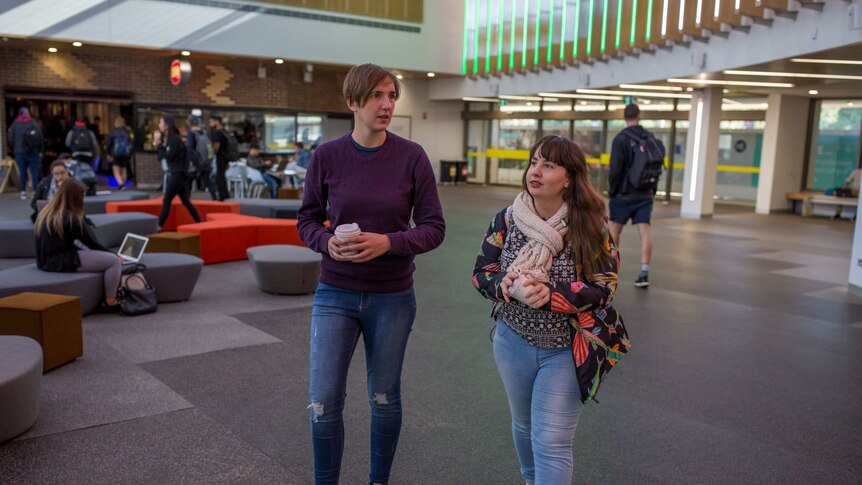 Shannon Colee walks with a friend on the Deakin University campus.