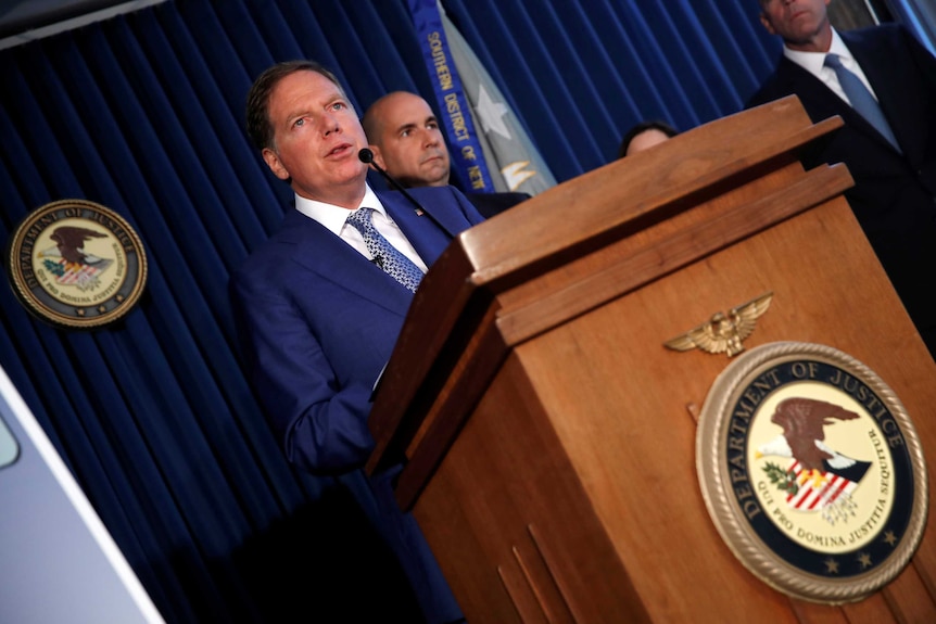 U.S. Attorney for the Southern District of New York Geoffrey Berman speaks at a lectern.