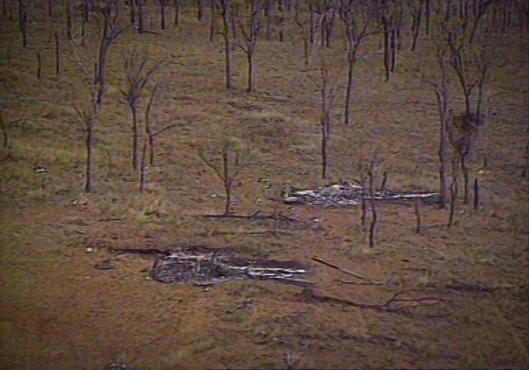 Aerial vision of two burnt helicopters.
