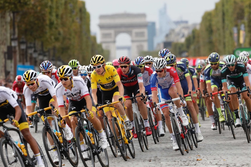 Tour de France winner ride down Chams Elysees avenue as the Arc de Triomphe is seen in the background.