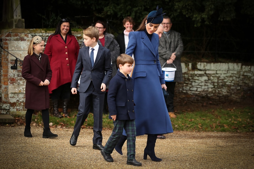 Catherine, Princess of Wales, Prince George, Prince Louis and Mia Tindall walk on a path after a church service.