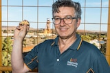 A geologist holding a gold nugget in the gold mining city of Kalgoorlie-Boulder.  
