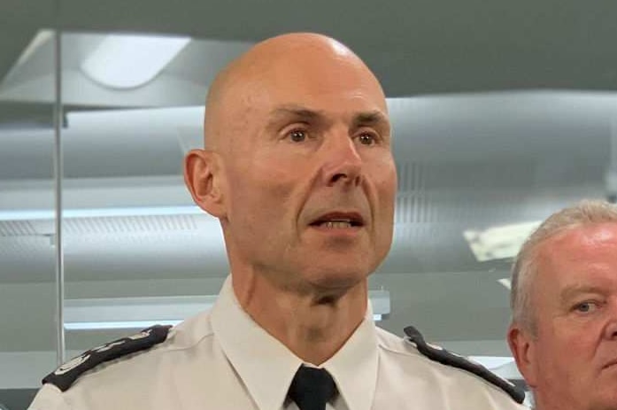 Victoria's Emergency Management Commissioner Andrew Crisp stands in front of a lectern.