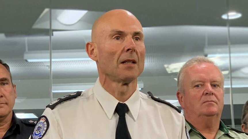 Victoria's Emergency Management Commissioner Andrew Crisp stands in front of a lectern.