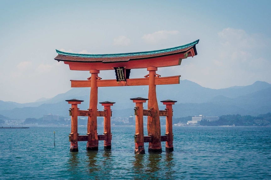 Shinto Itsukushima Shrine, Japan, a red wooden structure floating in the water.