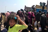 Rohingya refugees including children gather and climb onto a truck in Bangladesh.