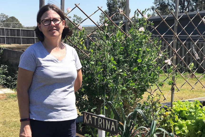 Katrina Gorton stands next to her garden patch in the community garden, near her home at Fitzgibbon Chase.