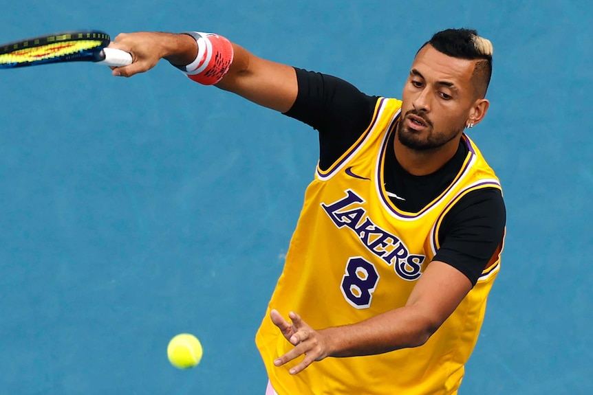 Nick Kyrgios hits a forehand during a warm-up wearing a Kobe Bryant #8 Lakers jersey