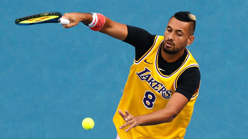 Nick Kyrgios hits a forehand during a warm-up wearing a Kobe Bryant #8 Lakers jersey