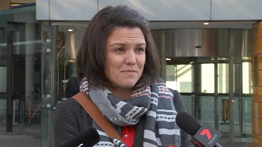 Simone Cameron stands and speaks to media outside the Federal Court building.