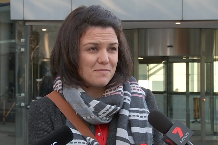 Simone Cameron stands and speaks to media outside the Federal Court building.