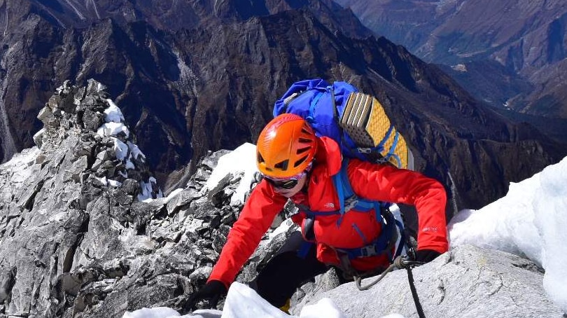 female mountaineer climbing