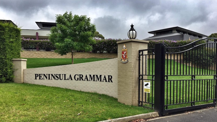 The gates to Peninsula Grammar, emblazoned with the school's crest.