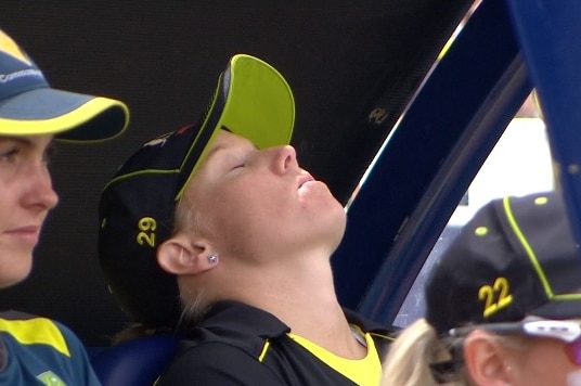 Alyssa Healy sits with her eyes closed and head back