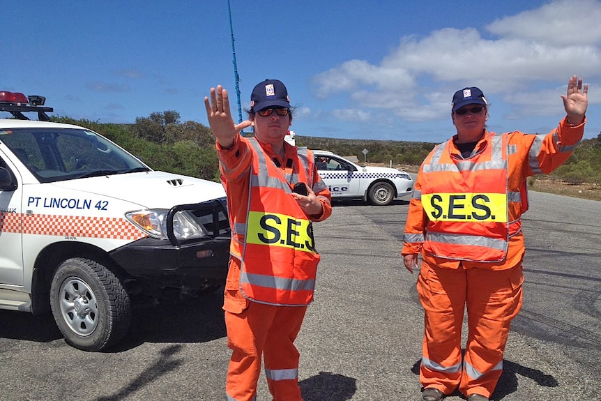 SES workers stop traffic from heading into the danger zone