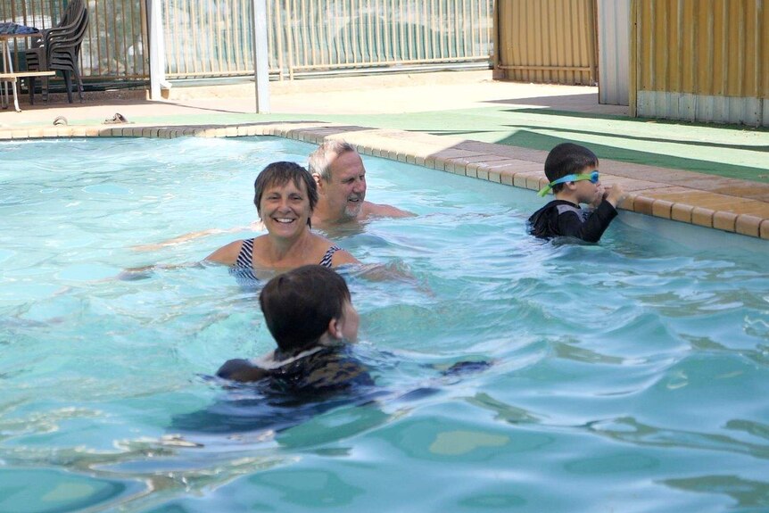 Senior Constable Shipley and her husband Dirk running a kids swim afternoon at the local pool