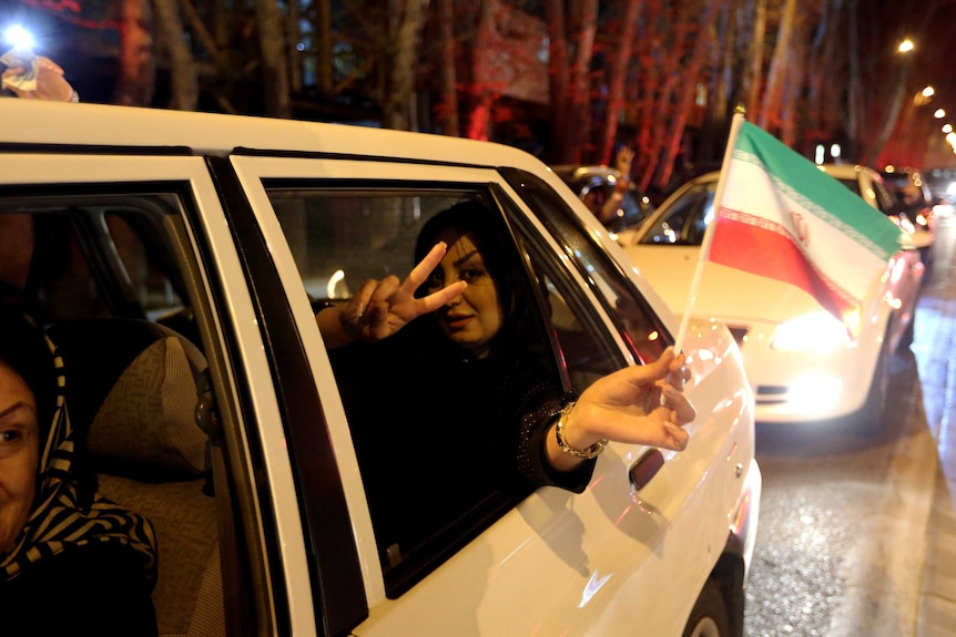 People celebrate after Iran nuclear deal