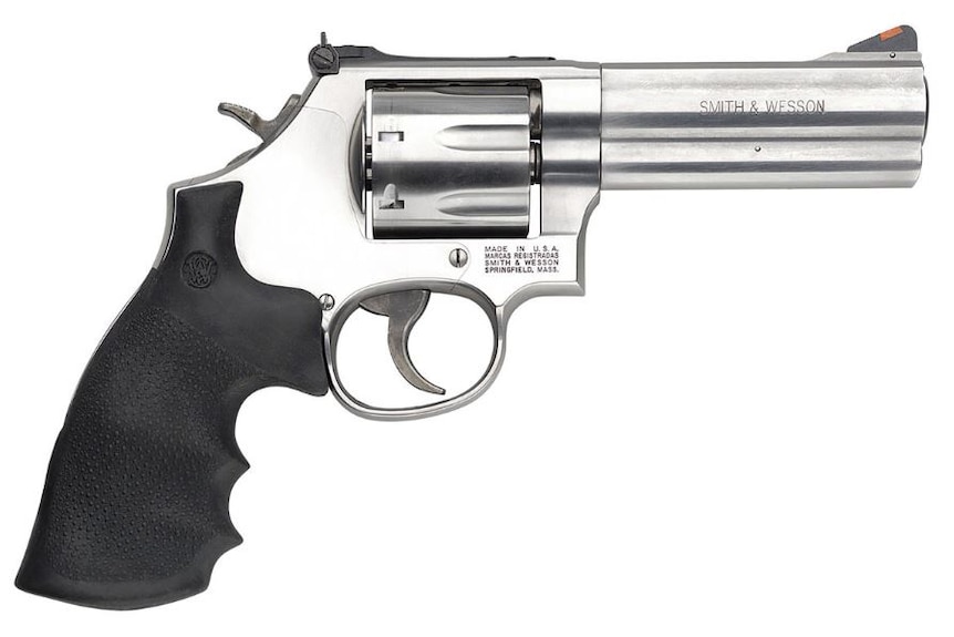 Photograph of a silver gun against a white background