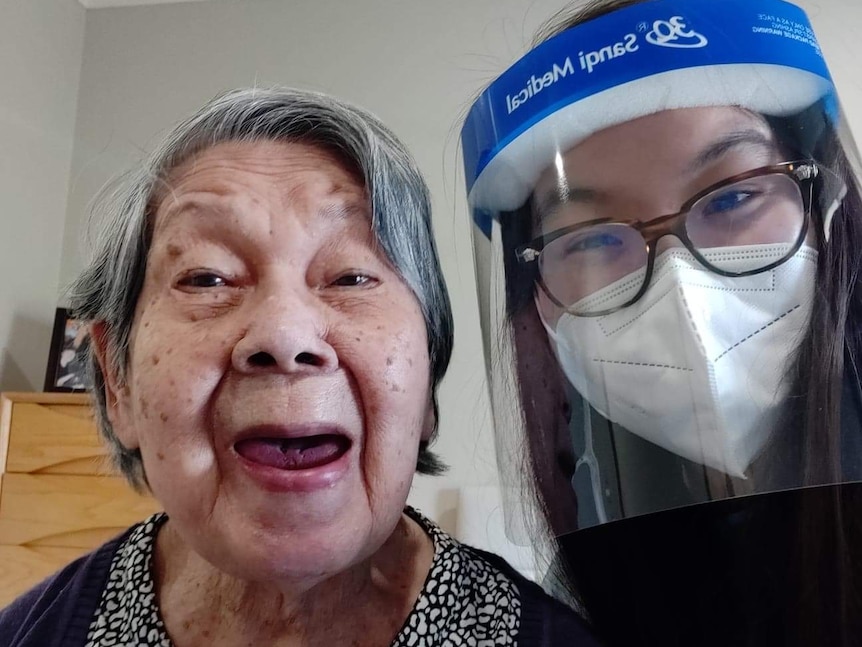 Ai-Lin Chang in a face shield with her grandmother.