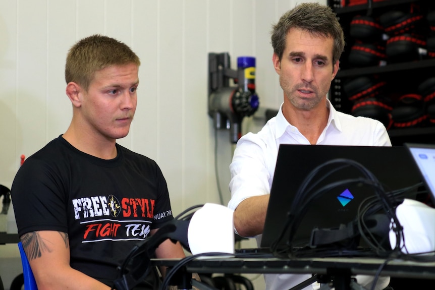 two men looking at computer