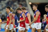 Brisbane Lions players leave the field against Geelong