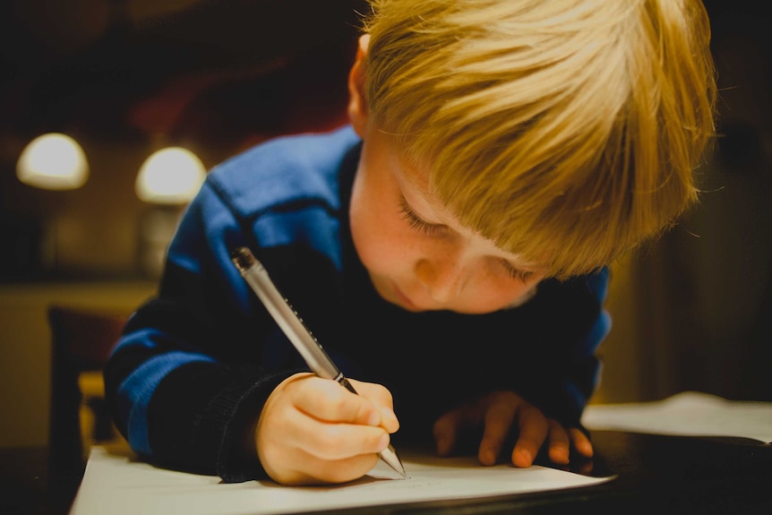 A young boy writes a letter to Santa