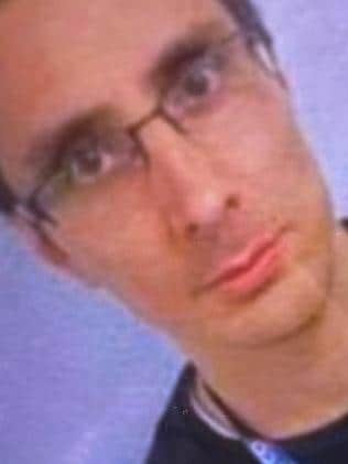 A close up photo of a man's face with glasses.