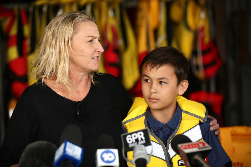 A woman and her son wearing life jackets