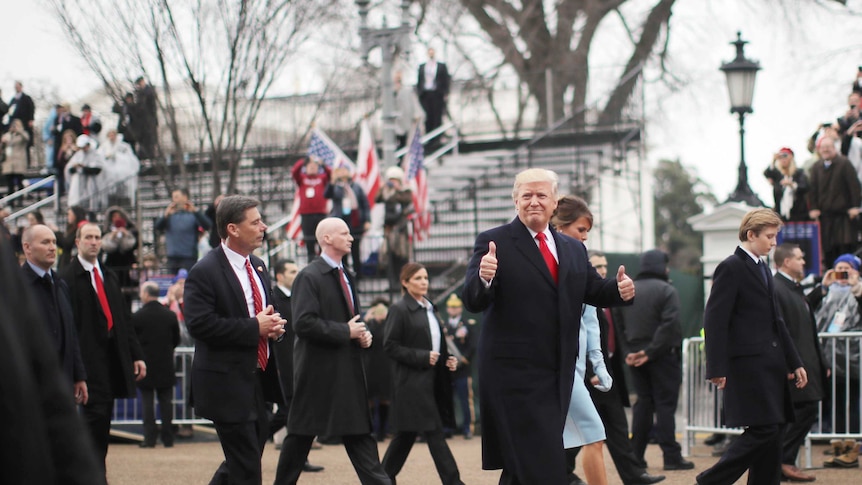 US President Donald Trump gives a thumbs up during his inaugural parade.