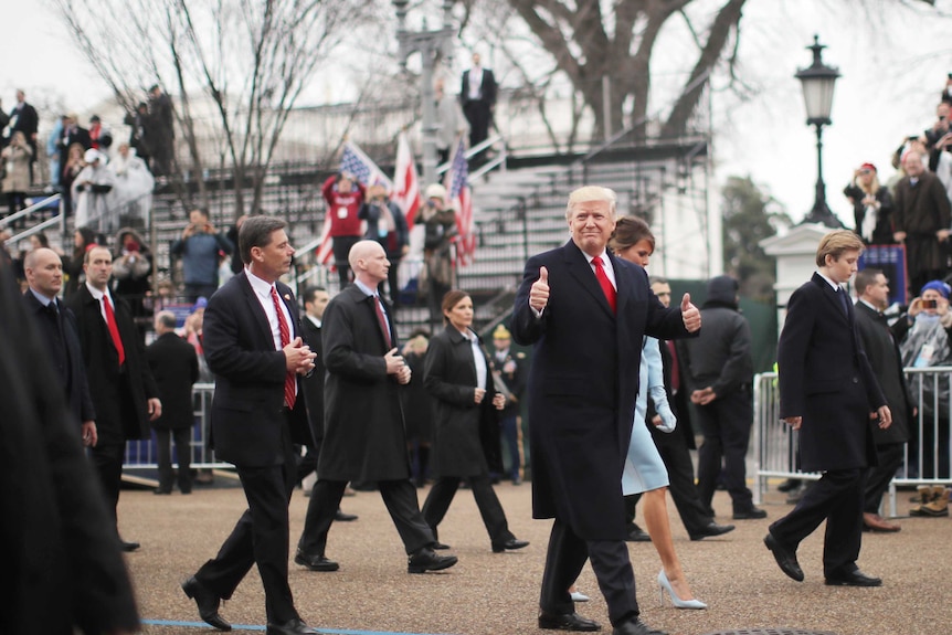 US President Donald Trump gives a thumbs up during his inaugural parade.