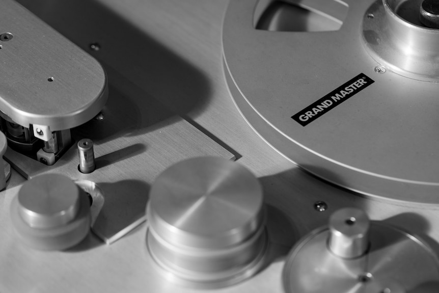 Silver dials of a vintage tape recording machine