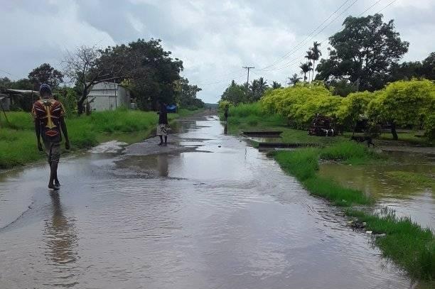 A road covered in water after recent flooding in Daru town. It appears to be a dirt road and is fully flooded.
