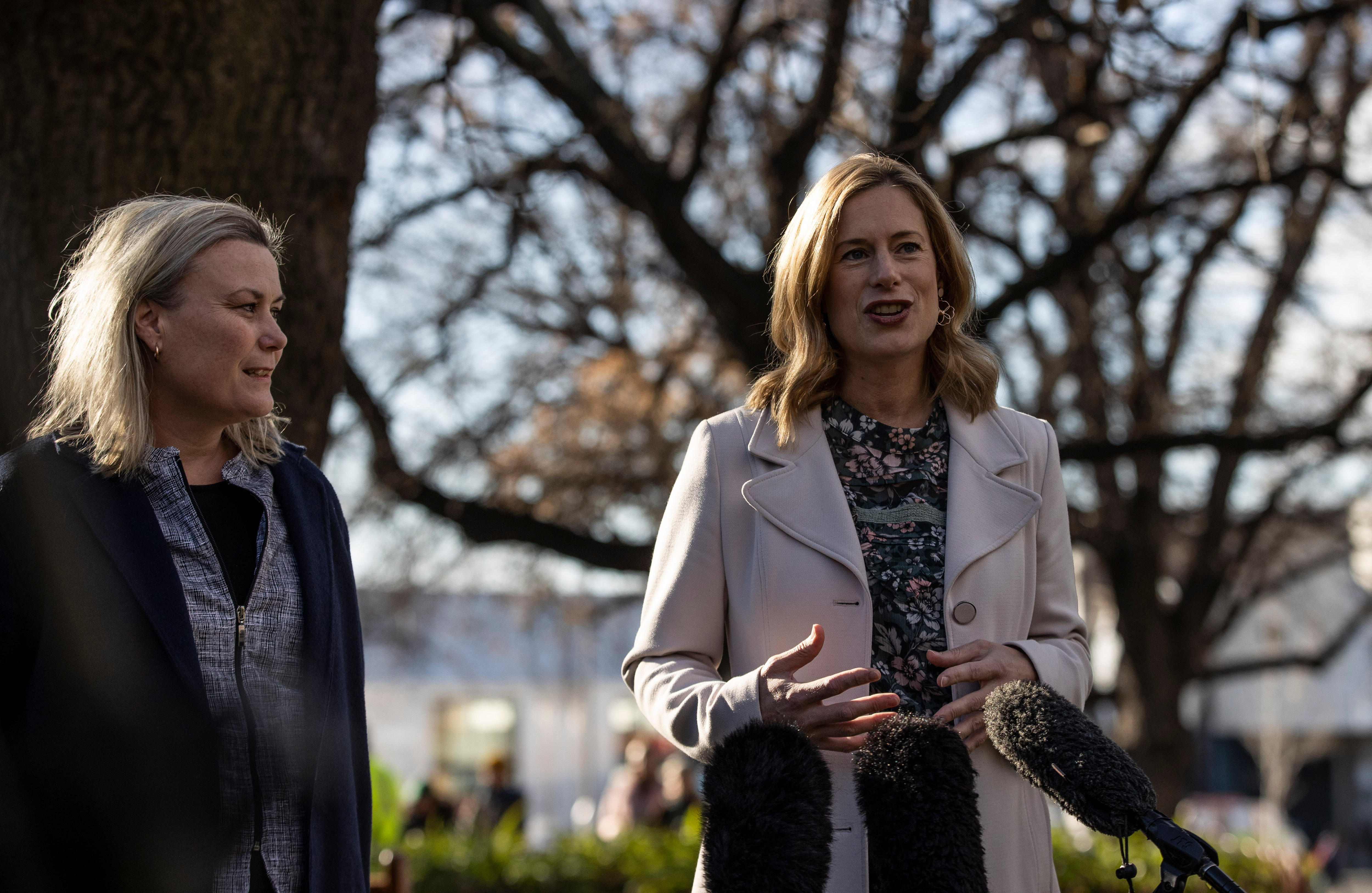 Rebecca White speaks outside, there is a tree in the background