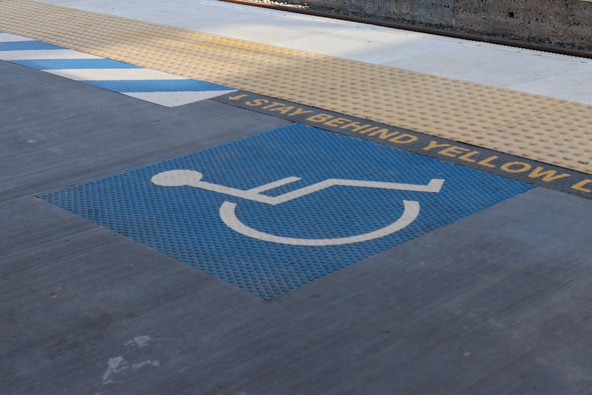 A disability symbol on a train platform.