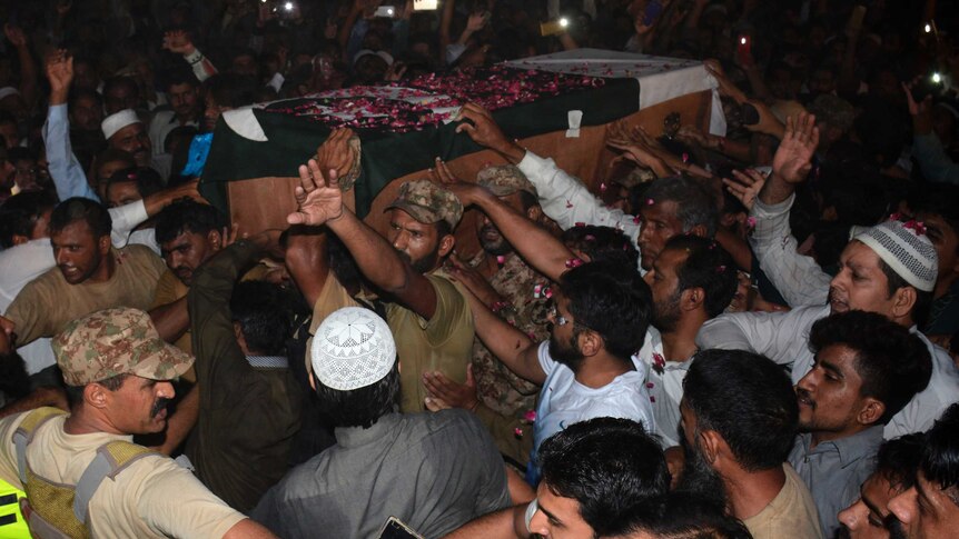 Pakistani military officials, relatives and residents carry the coffin of a Pakistani soldier, killed in firing along the Line of Control that divides the disputed territory of Kashmir.