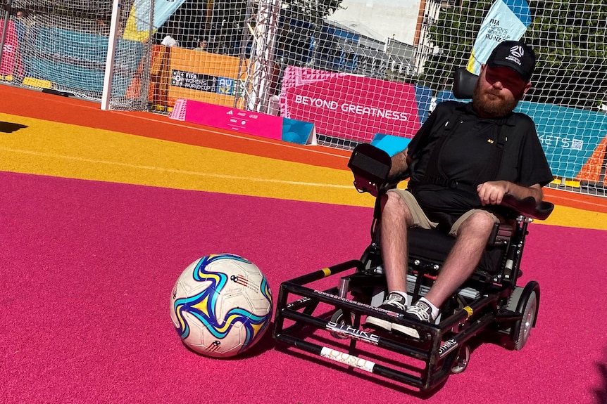 Tristram Peters dribbles the ball in his powerchair