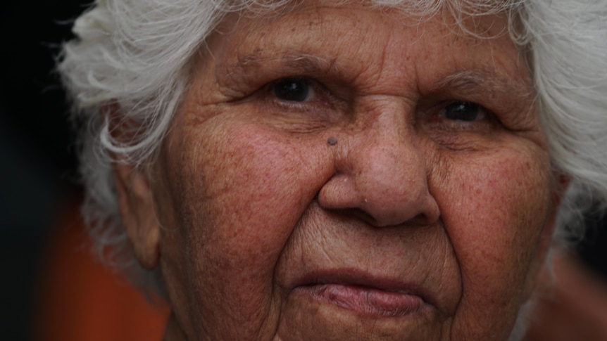 An up close photo of an older woman looking at the camera.