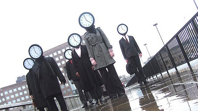 Clock faced commuters promoting a British work-life balance event (Johninnit - Flickr)