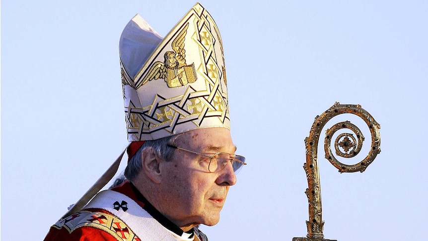 Cardinal George Pell, pictured in 2008, wears a headdress and holds a staff.