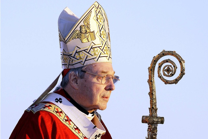 Cardinal George Pell, pictured in 2008, wears a headdress and holds a staff.