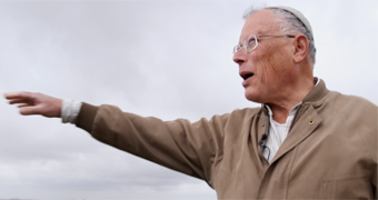 Dr Hagai Ben-Artzi on high ground, gesturing out across the land below.