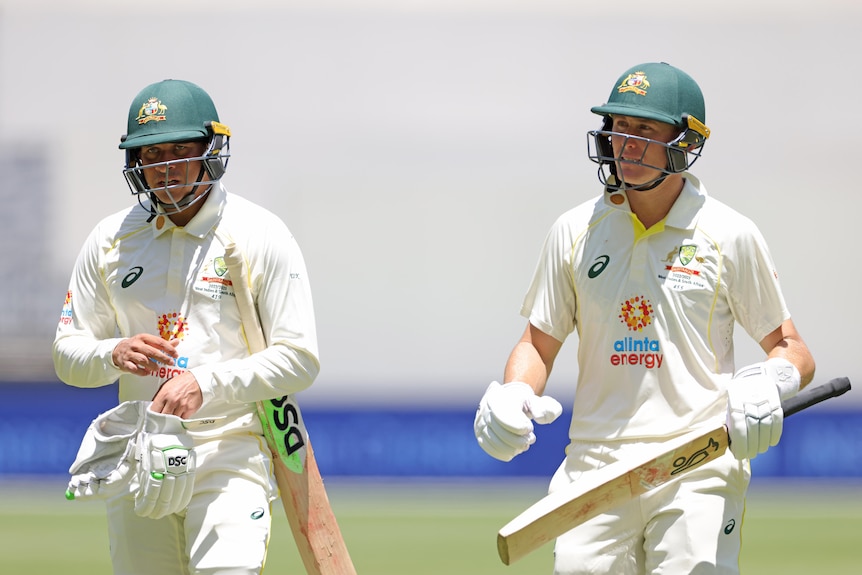 Usman Khawaja and Marnus Labuschagne walk together in batting gear