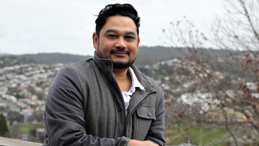 Anwarul Islam Khan smiles at the camera.